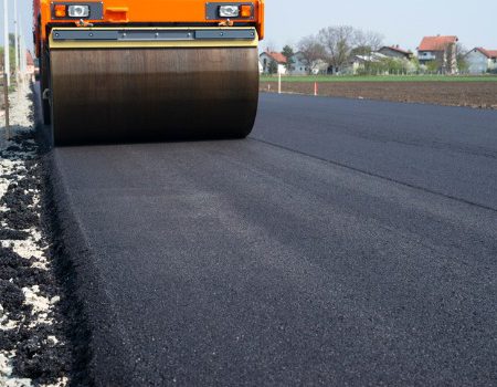 asphalt-paving-steamroller-machine-flattening-new-layer-of-asphalt-picture-id1148506736